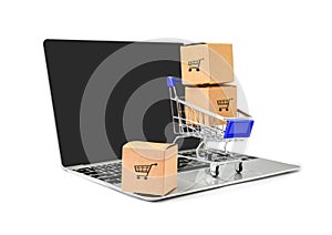 Boxes in a trolley on a laptop keyboard on whiteÂ  background with clipping path. Concepts about online shopping
